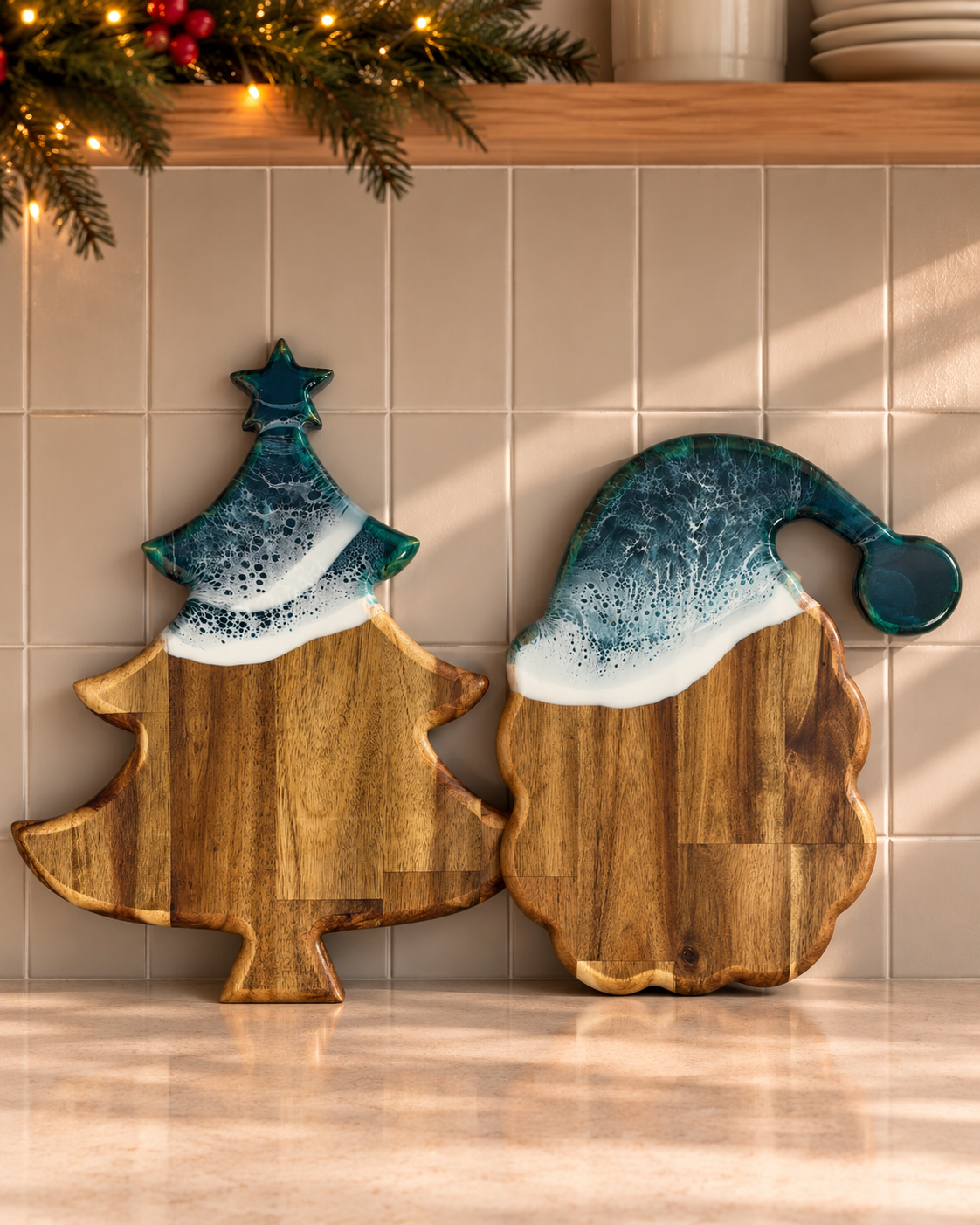 Two wooden holiday serving boards with ceramic topper shapes, one Christmas tree and one Santa hat, displayed on a tiled kitchen backsplash.