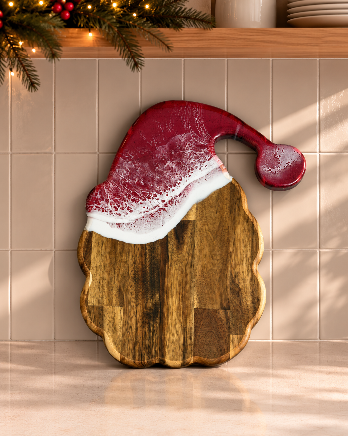 A wooden Santa hat shaped serving board with a red and white faux-fur trim, leaning against a beige tiled wall in a kitchen setting.