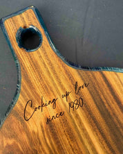 The back side of a round paddle where the customer has engraved on the back at the top of the handle