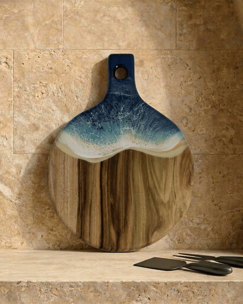 A round paddle board in the beach coloured resin shot in against a kitchen splashback