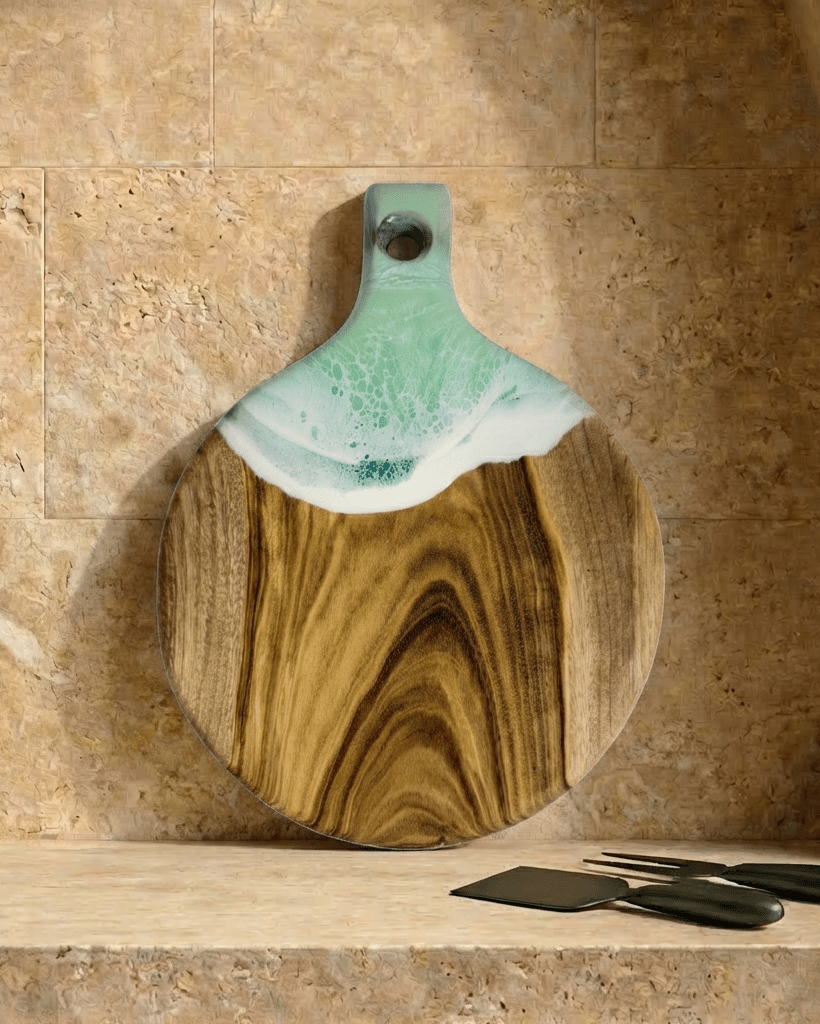 A round paddle board in the mint coloured resin shot in against a kitchen splashback