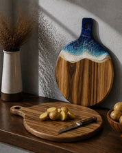The board being display on the splash back with the resin side facing out, and on the bench the round paddle board is flipped over to demonstrate how to chop on the back of the boards