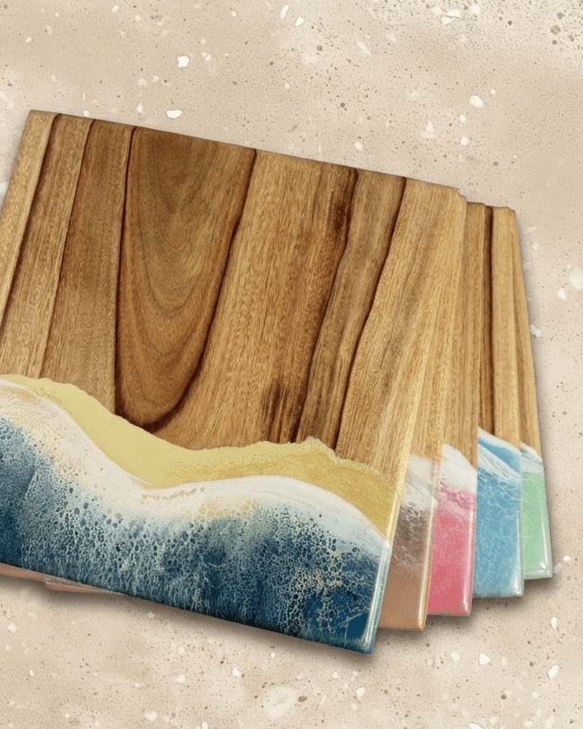 A set of square wooden serving boards featuring a resin wave design in all 5 art of elements colours beach, pink, mint green, light blue/ esperance and neutral. 
