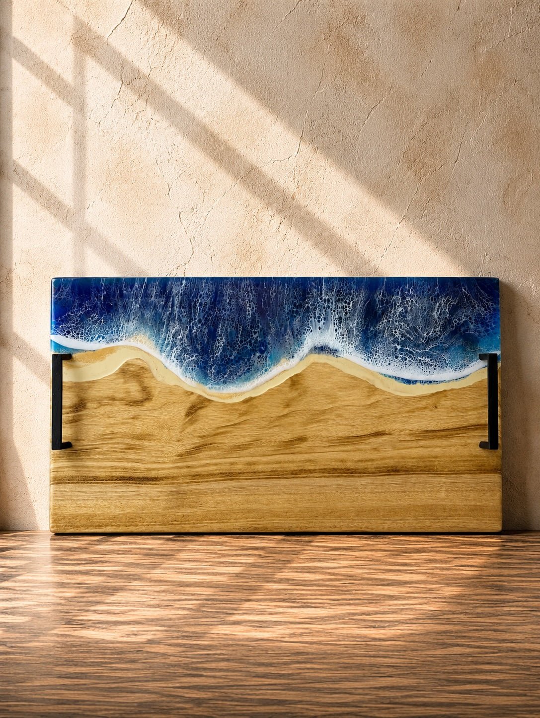 Wide handle serving platter with beach blue resin on the long edge and matte black carry handles for practicality 