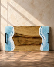 Wide handle serving platter with light blue resin on each short edge and matte black carry handles for practicality 