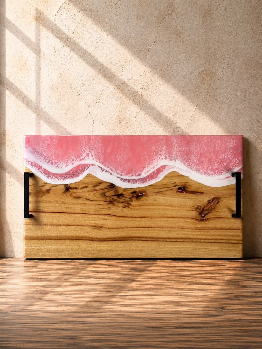 Wide handle serving platter with pink resin on the long edge and matte black carry handles for practicality 