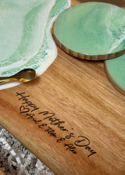 Wide handle serving board with the mint green waves and matching coasters  engraved text 'Happy Mother's Day'  and the kids names